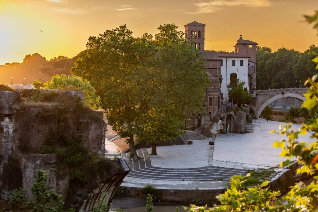 Isola Tiberina or Isola Tiberina in Rome.Italy. Isola dei Due Ponti, Licaonia, San Bartolomeo Island at sunset. An ancient river island of the Tiber with historical monuments, center of Rome.