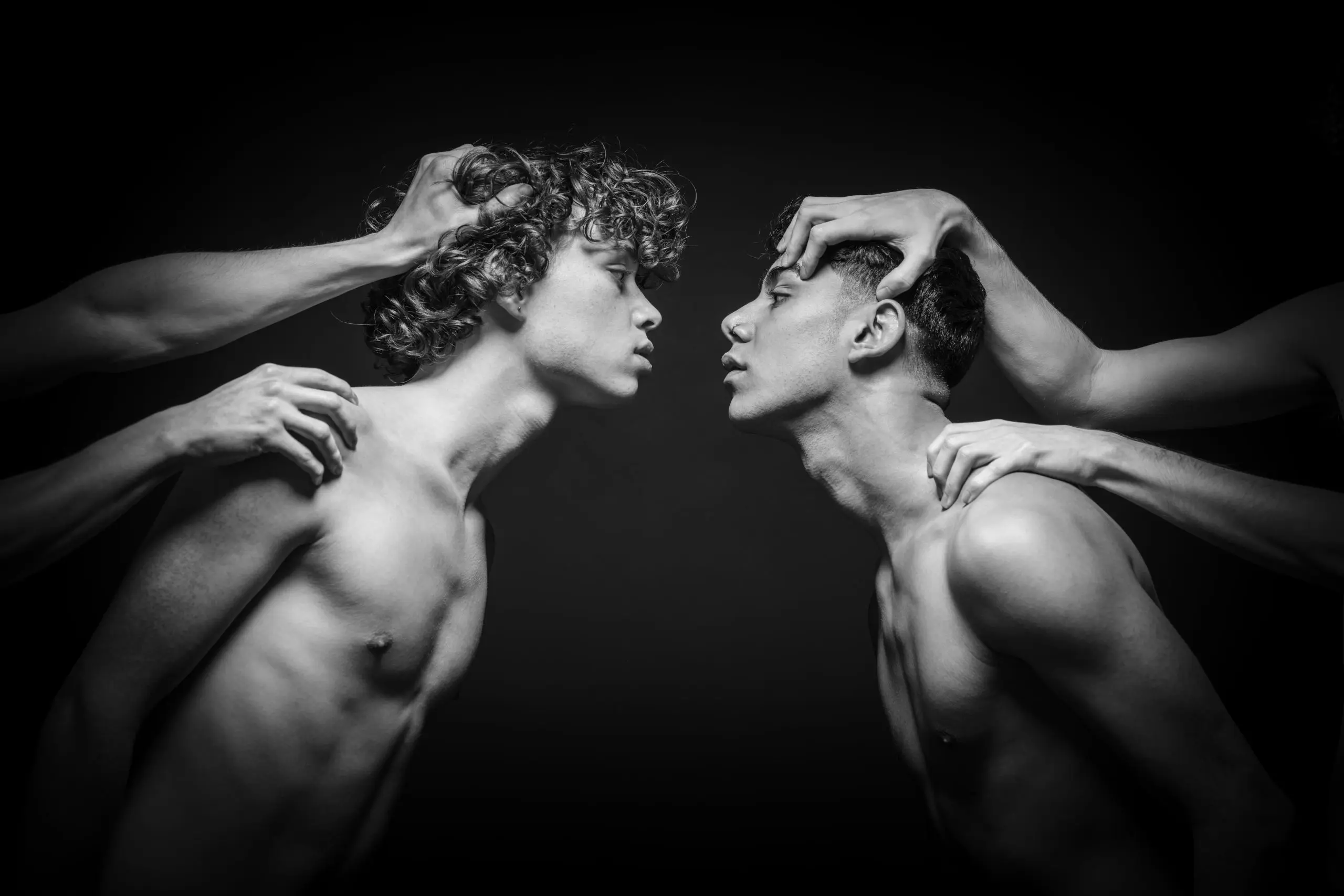 Two men looking at one another in black and white.