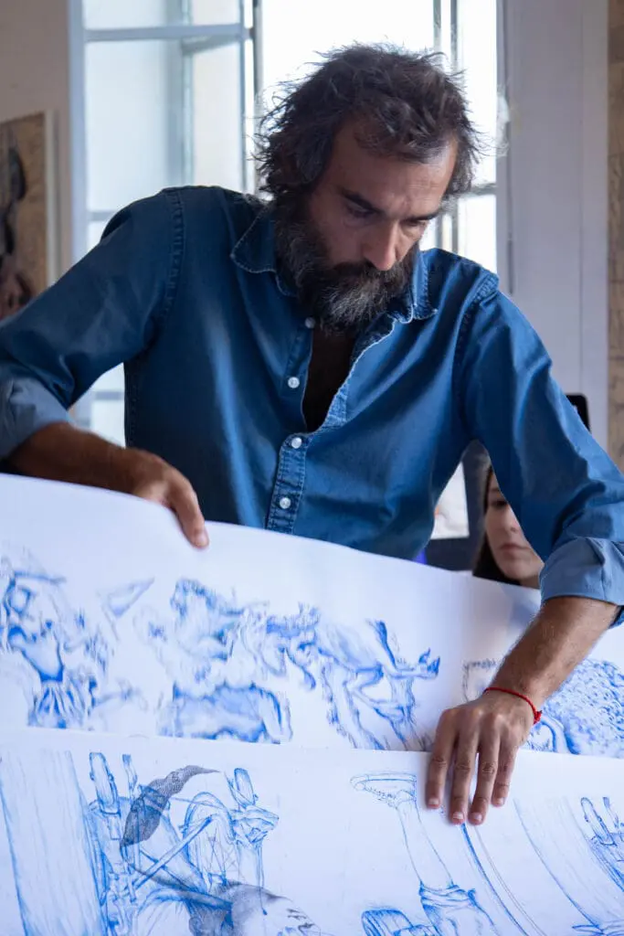 Artist Pietro Ruffo holding a piece of his artwork