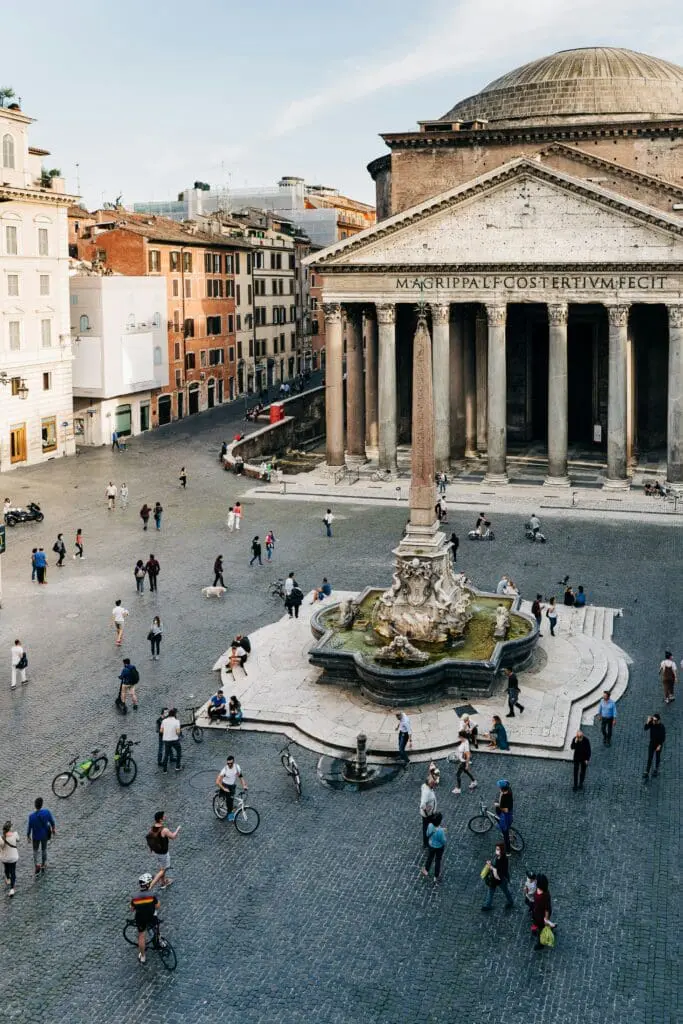 People walking around Fontana del Pantheon Square in Rome, Italy