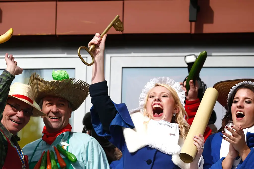 A woman celebrates in Cologne, holding up the key to the city as part of Fat Thursday and Karneval.