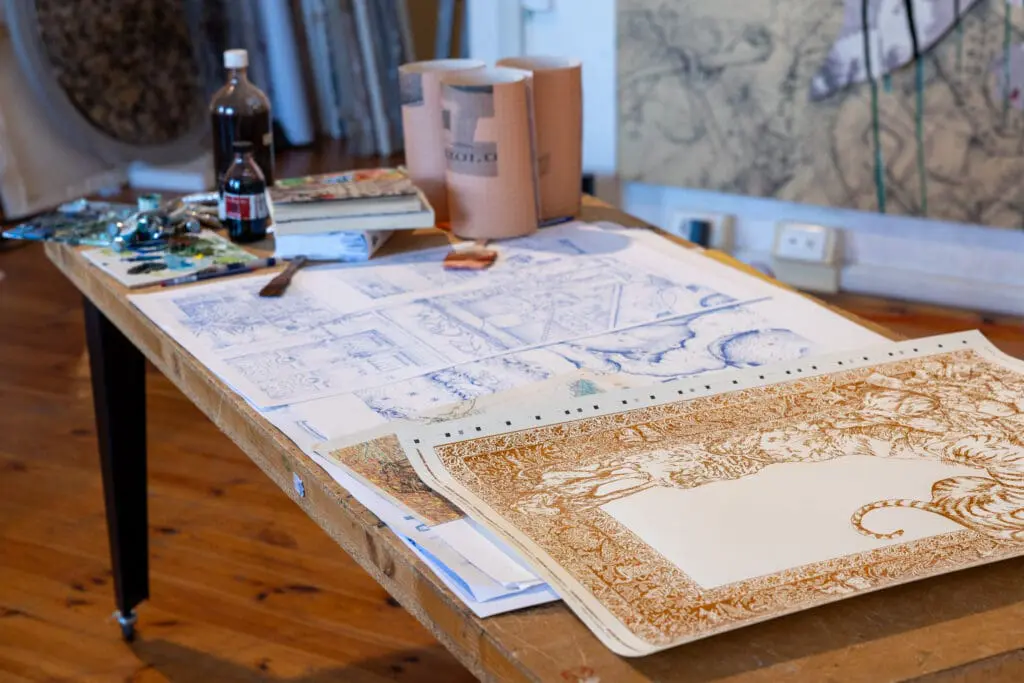 Various works from Pietro Ruffo placed on top of a desk in his workshop in Rome.