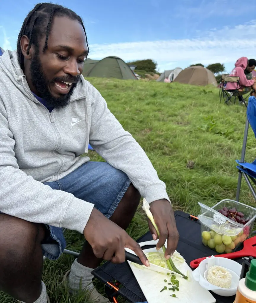 Man from Kez Camp Black Camping Club chopping food