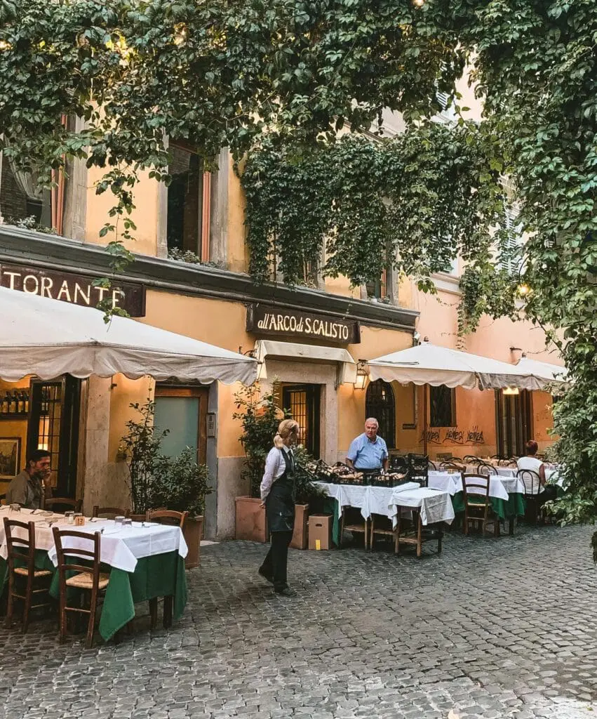 Two people setting up a restaurant in the Monti district in Rome, Italy