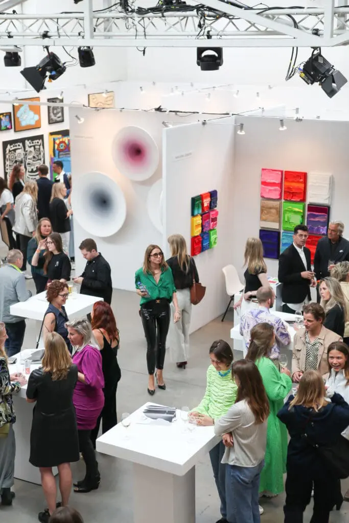 People looking at various artwork at an art fair led by NockNock