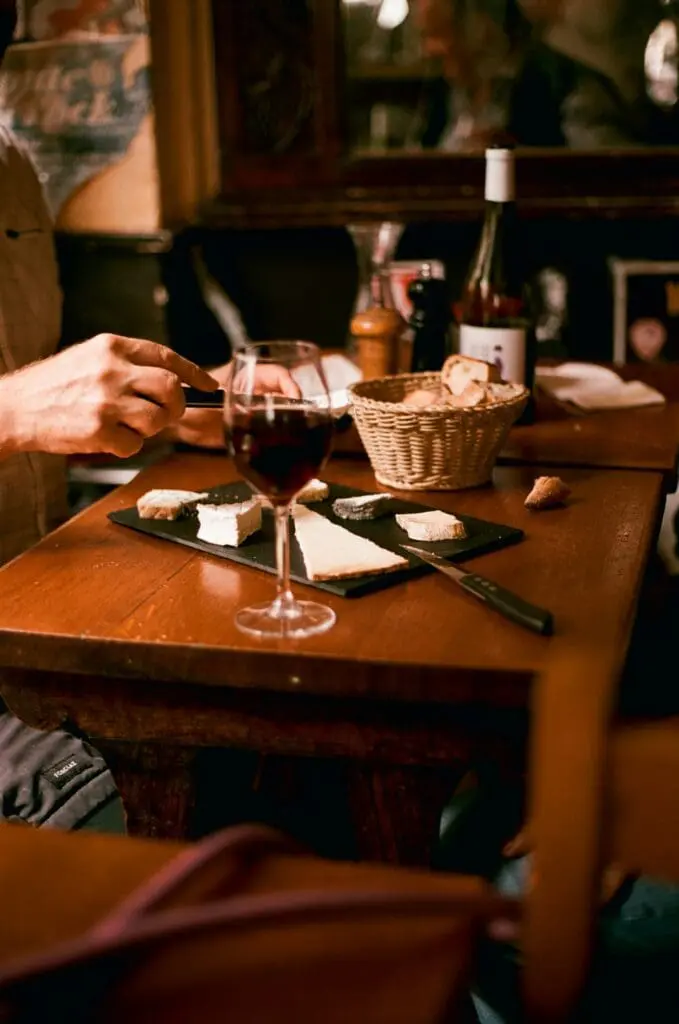 A glass of wine and cheese board at at Il Goccetto in Rome, Italy