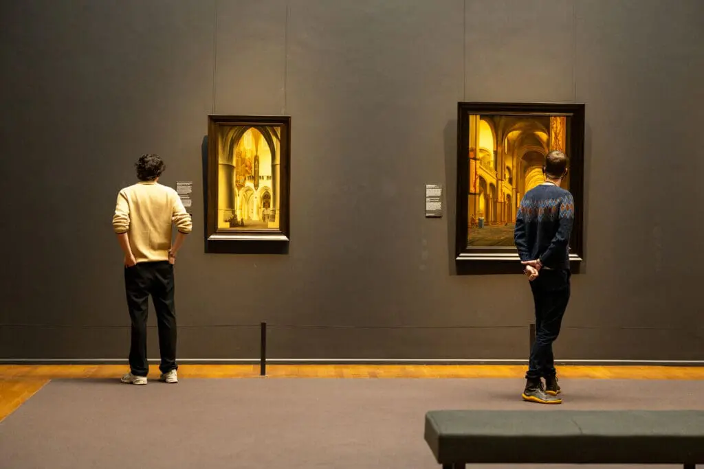 Two people looking at artwork in the Rijksmuseum in Amsterdam