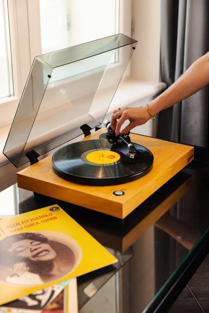 Vintage-style record player at art gallery art’otel hotel Rome with wooden base, vinyl record, and modern interior.