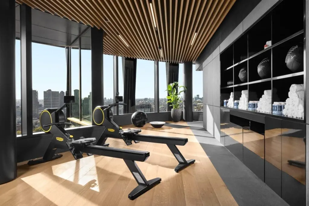 Indoor gym at art'otel London Hoxton Old Street hotel with pool.