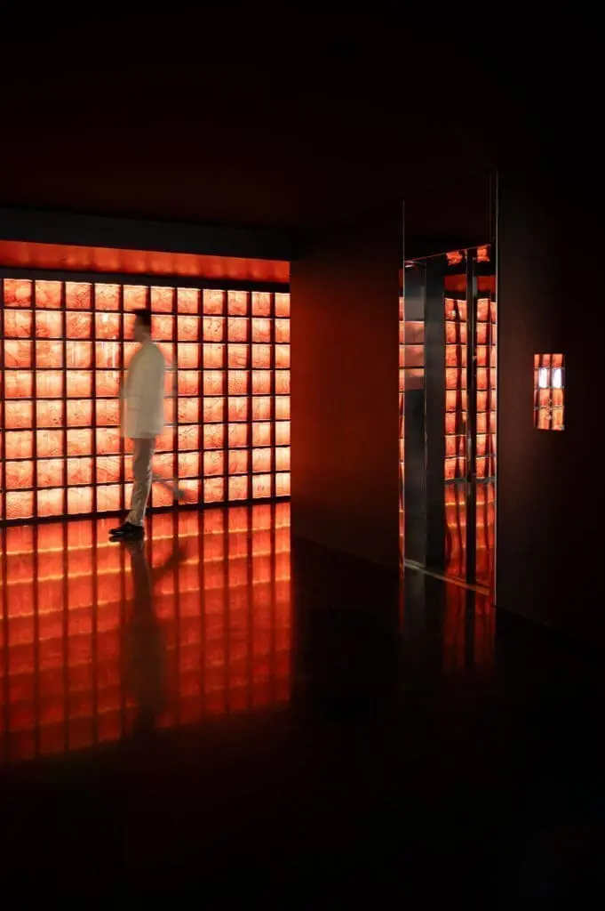 Modern hallway with glowing red illuminated wall panels at art'otel Yezi restaurant Roma