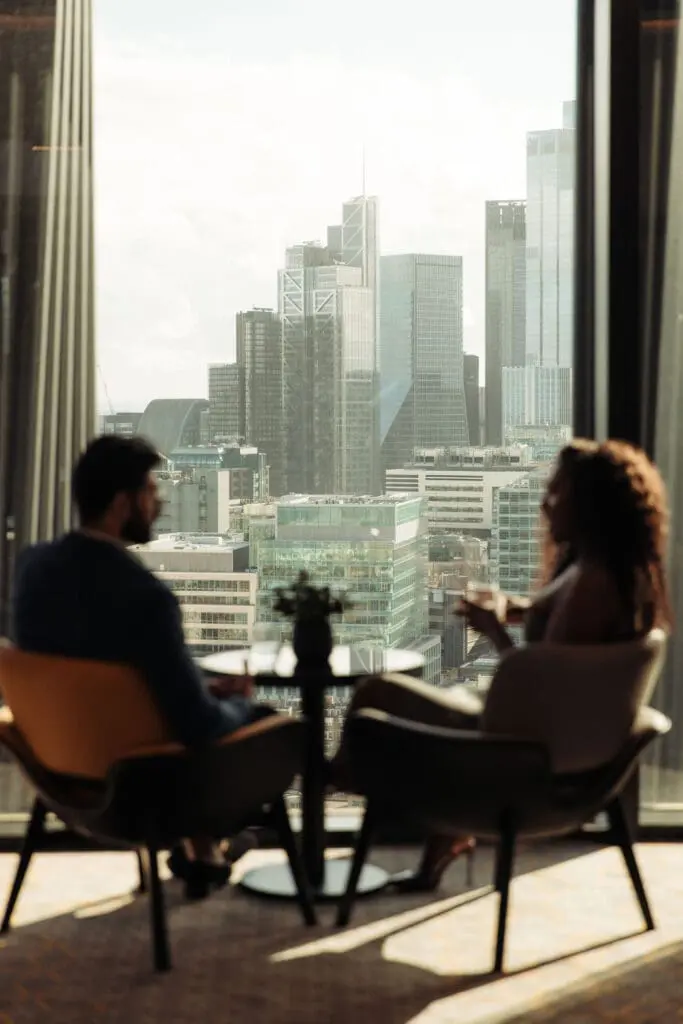 City view from art'otel London Hoxton Shoreditch hotel with pool, featuring modern skyline and stylish lounge seating.