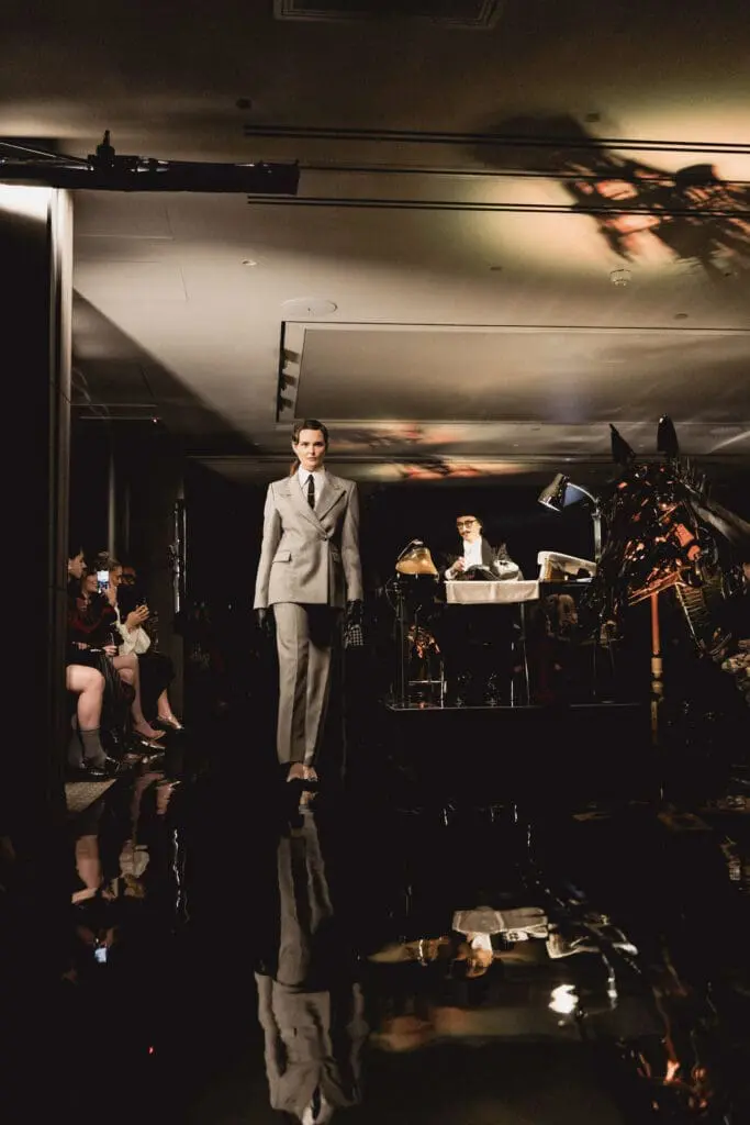 Fashion runway show with tailored suit and artistic backdrop at art exhibition Shoreditch London
