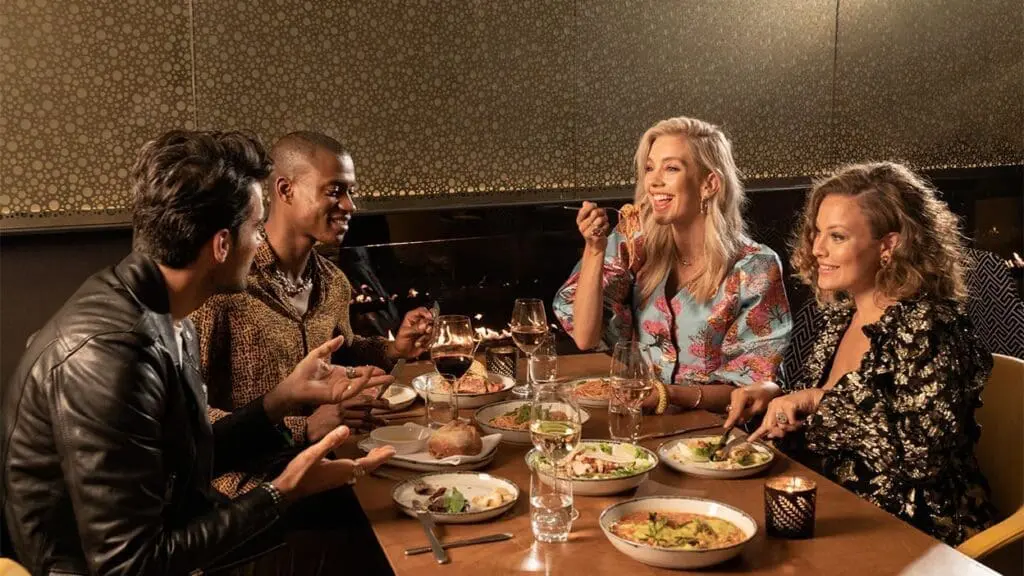 Group dining at art’otel Battersea Power Station restaurant & bar with gourmet dishes and wine