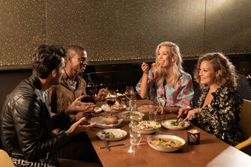 Group enjoying dinner and drinks at art'otel Battersea Power Station restaurant & bar.