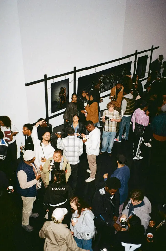 Crowd of people socializing at contemporary art exhibition in Shoreditch London