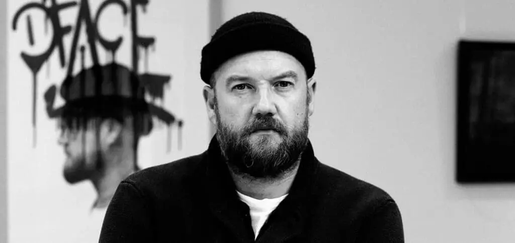 A D*Face wearing a black hat and black sweater at art'otel London Hoxton Old Street hotel