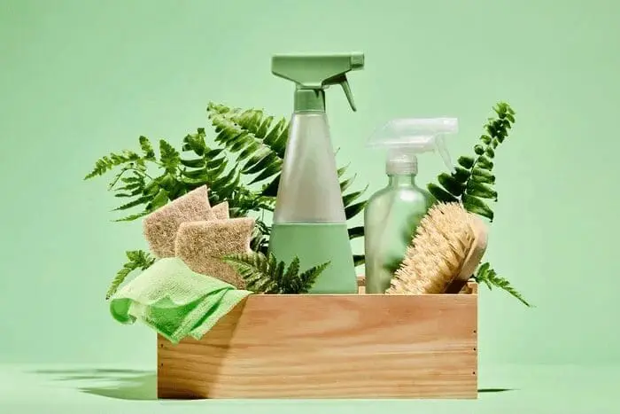 Eco‑friendly cleaning products arranged in a wooden box with greenery, reflecting sustainable guest amenities offered at art'otel Hotel next to Battersea Power Station.