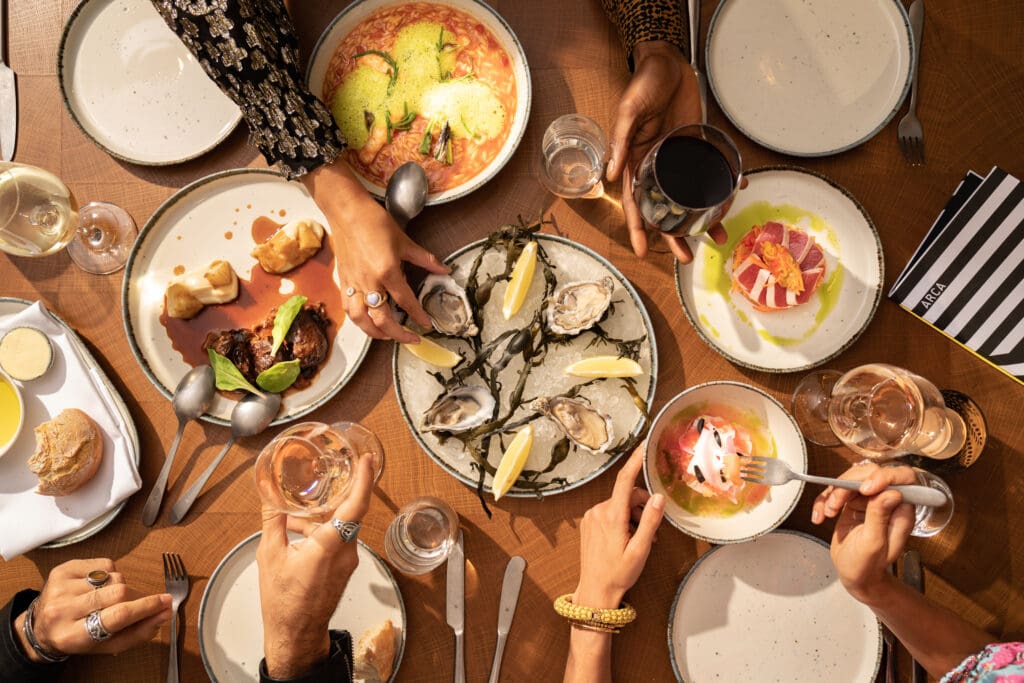 A table of plates with food at ARCA restaurant.