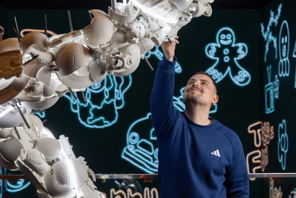 Man interacting with white sculptural art installation at art exhibition Old Street.