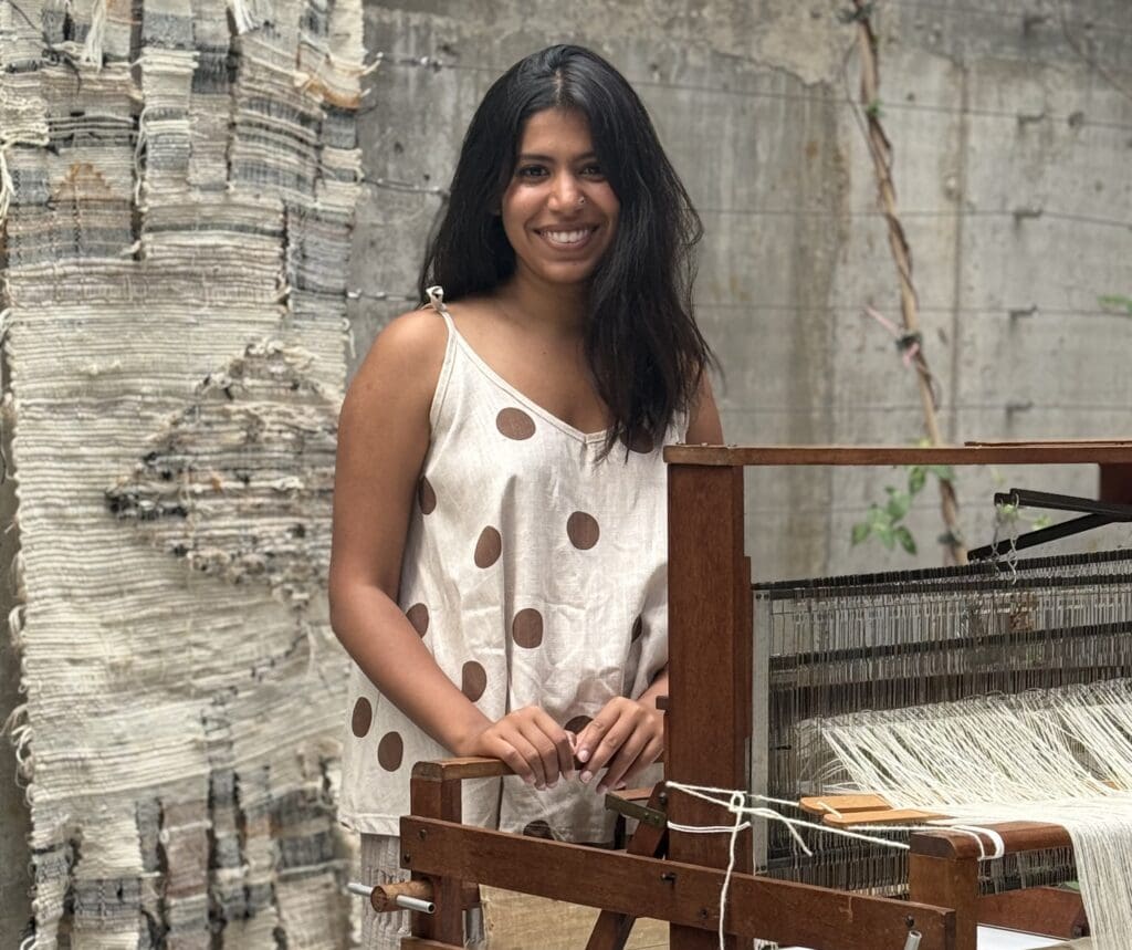 Textile art exhibition Shoreditch featuring handloom weaving and woven fabric backdrop.